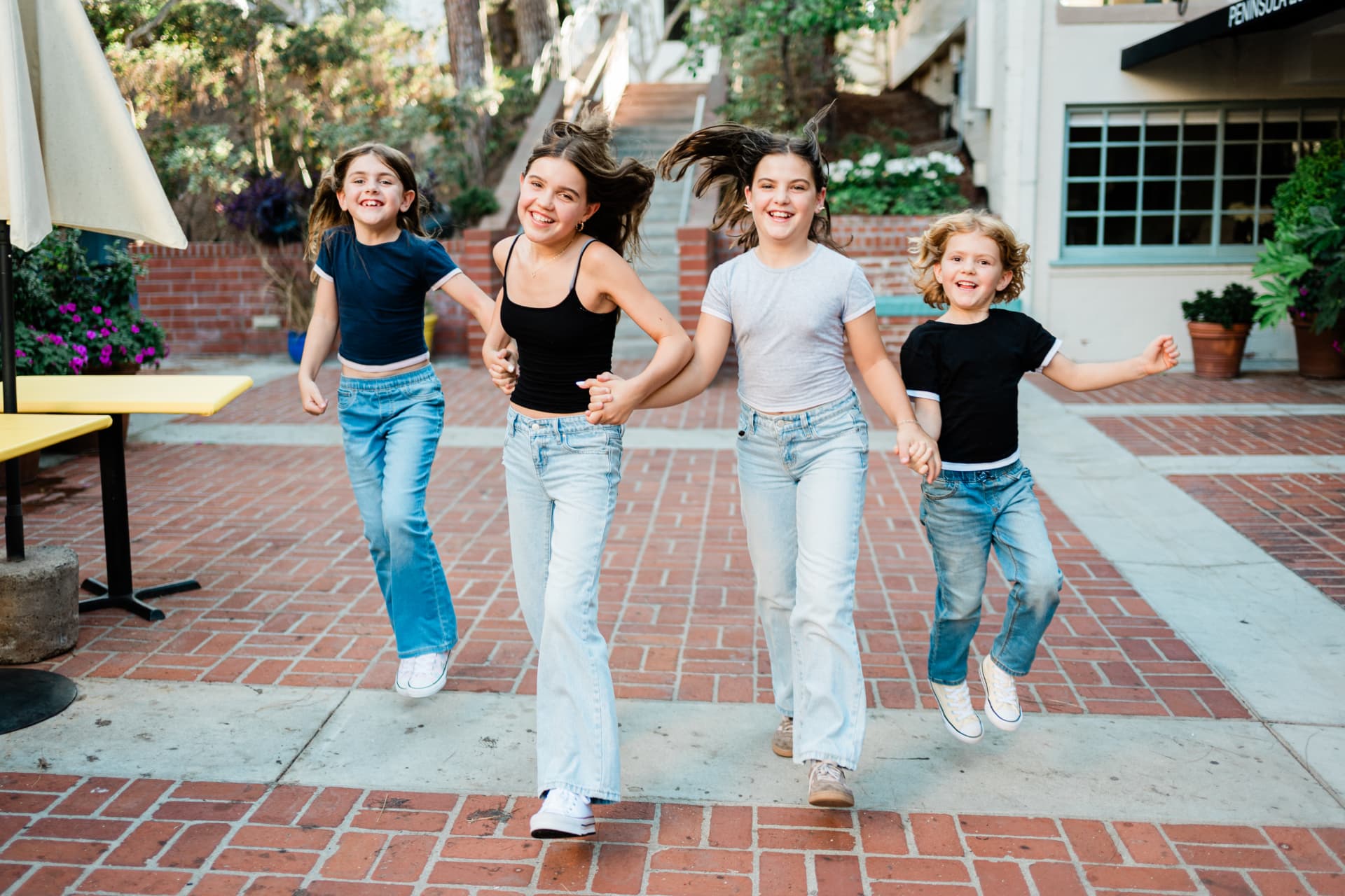 Four sisters running and holding hands