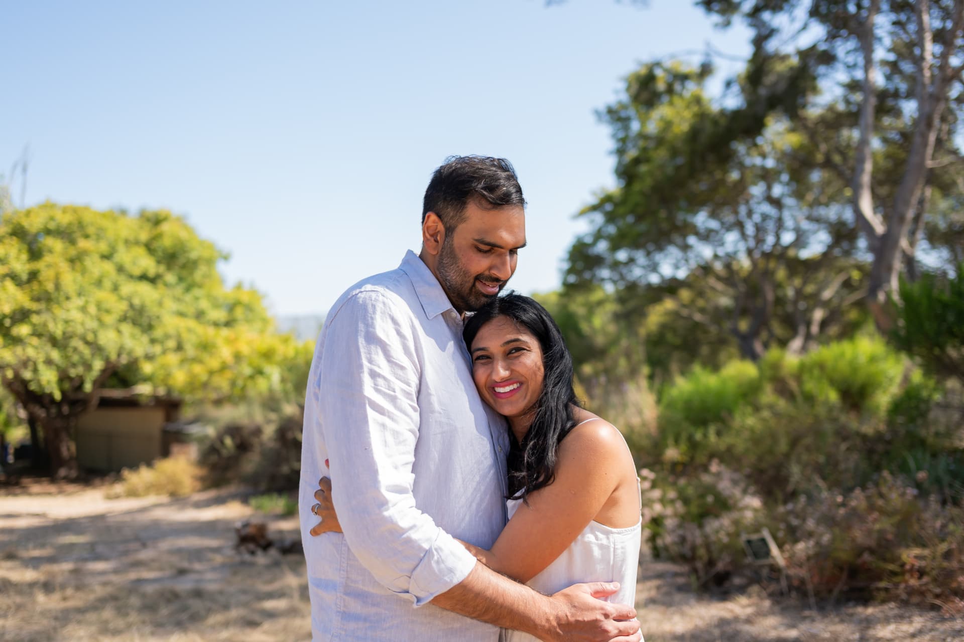 Couple embracing on a garden path